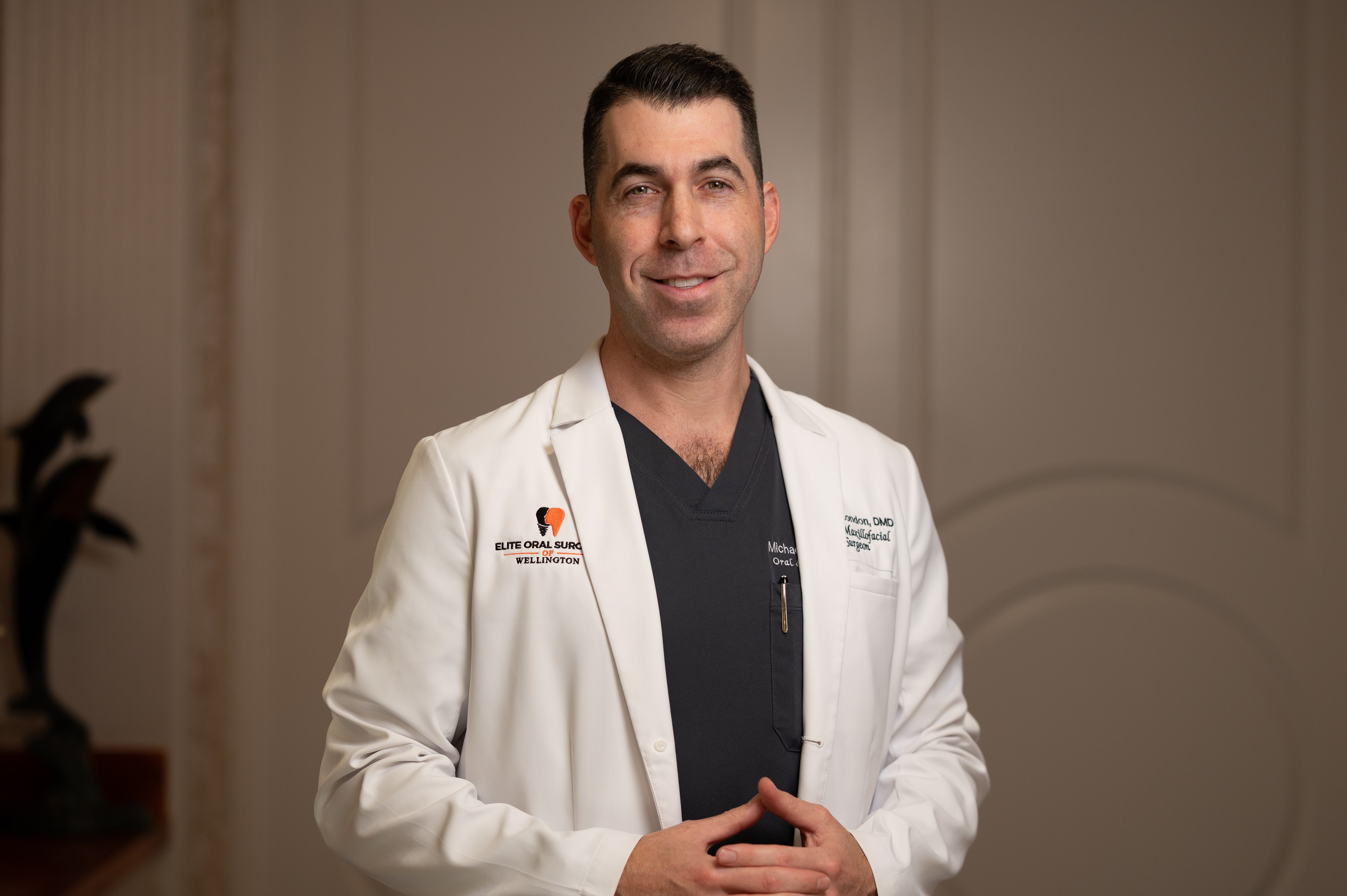 Dr. Michael London smiling in office